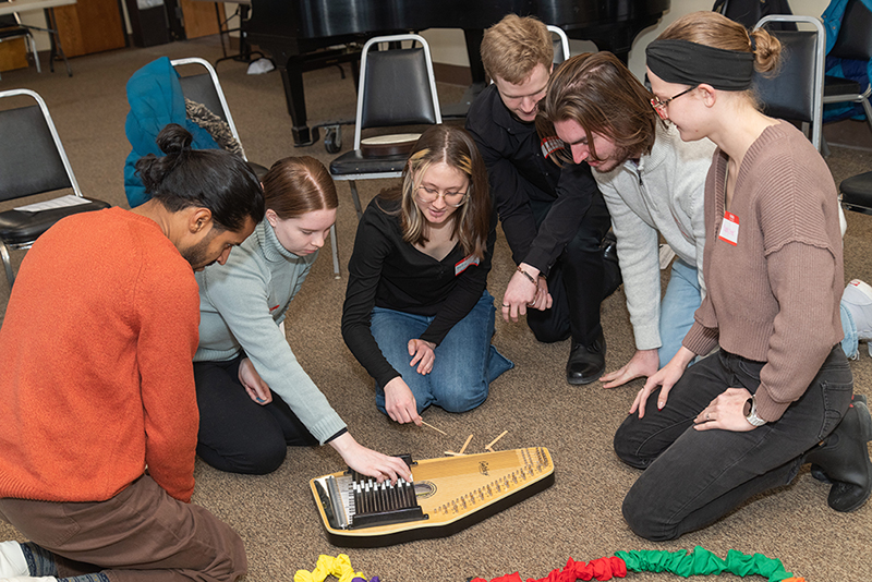 students around an instrument